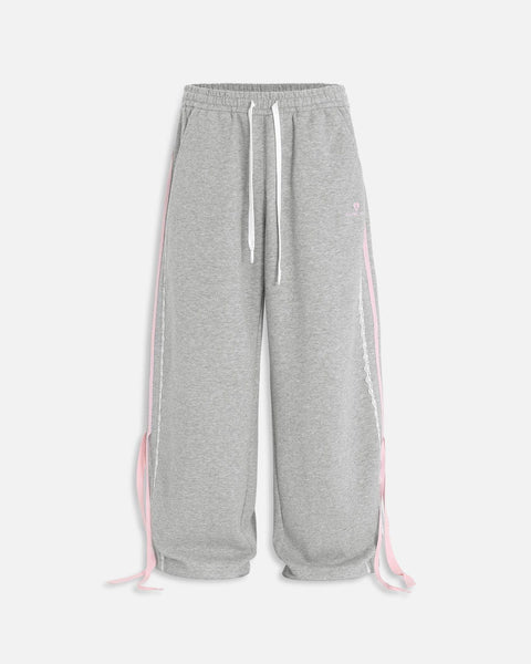 Pantalón baggy con bandas rosas y lazos laterales