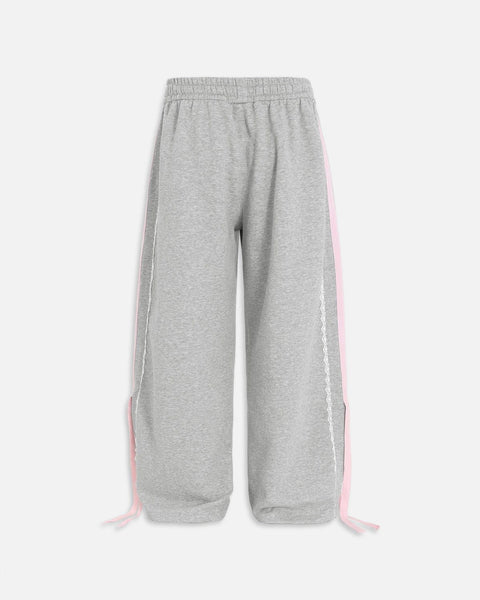 Pantalón baggy con bandas rosas y lazos laterales